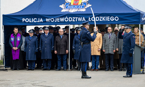 Dowódca składa meldunek komendantowi wojewódzkiemu policji w Łodzi, z tyłu pod namiotem stoją policjanci i zaproszeni goście.