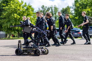 na zdjęciu robot na wyposażeniu SPKP i uczniowie klasy policyjnej.