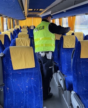 policjant we wnętrzu autokaru podczas kontroli.
