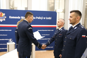 Zastępca Komendanta podaje rękę policjantowi.