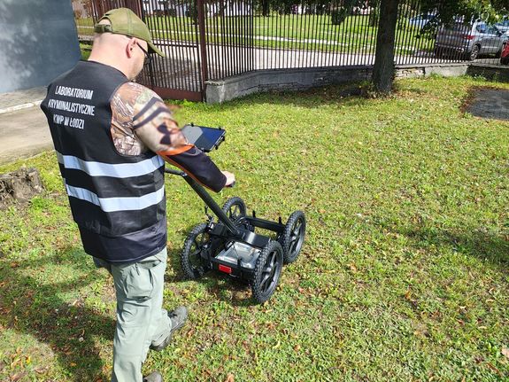 Policjant w trakcie użytkowania georadaru.