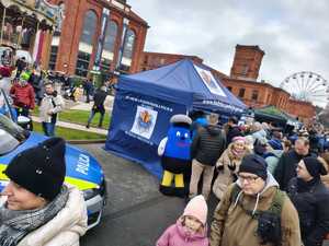 Namiot policyjny ludzie dookoła namiotu.