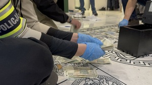 Funkcjonariusz zabezpiecza pieniądze.