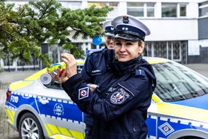 Policjantki Wydziału Ruchu Drogowego KWP w Łodzi wieszają odblaski.