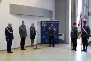 widac poczet sztandarowymi oraz komendanta wojewódzkiego policji w Łodzi, prowadzącego uroczystośc policjanta oraz dwoje lektorów