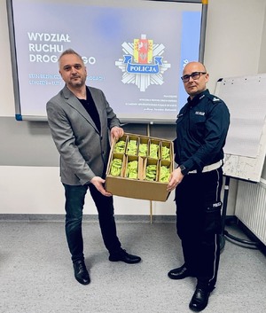 Dyrektor Wojewódzkiego Ośrodka Ruchu Drogowego w Łodzi, Michał Gogolewski, przekazuje na ręce Naczelnika Wydziału Ruchu Drogowego Komendy Wojewódzkiej Policji w Łodzi podinspektora Jarosława Złotkowskiego 8 tysięcy elementów odblaskowych.