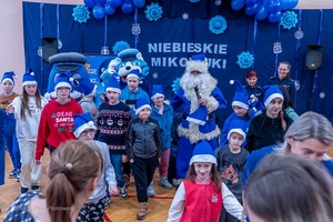 Policjanci wraz z dziećmi podczas świątecznego wydarzenia pod nazwą Niebieskie Mikołajki.