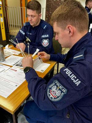 Policjanci wypełniają dokumenty.