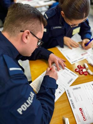 Policjanci wypełniają dokumenty.
