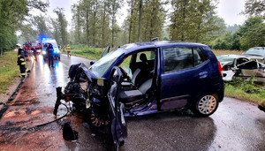 radiowóz na miejscu wypadku drogowego, przed nim uszkodzony pojazd biorący udział w wypadku