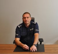 Komendant Miejski Policji w Łodzi siedzi za biurkiem