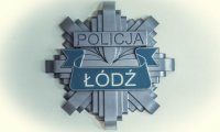 Na obrazku jest umieszczona szara gwiazda policyjna , w górnej części jest umieszczony napis policja, po środku , na niebieskim tle widać napis Łódź.