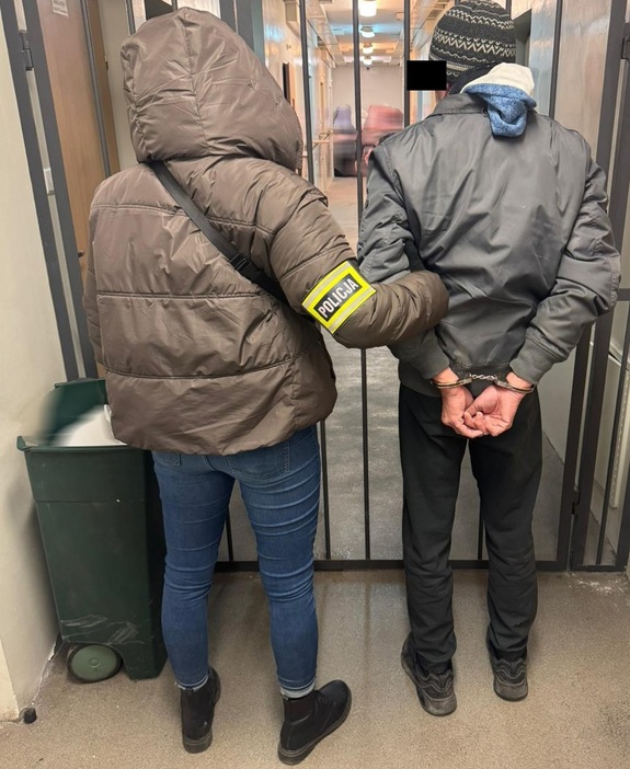 Zatrzymany prowadzony przez policjantkę.