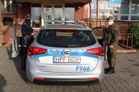 policjantka ze Skierniewic z zołnierzem WOT wsiadają do radiowozu zaparkowanego przed skierniewicką komendą policji