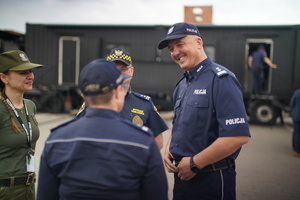 Zastępca Komendanta Wojewódzkiego Policji w Łodzi w trakcie rozmowy z innymi osobami