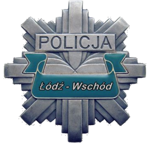 Odznaka policyjna w kształcie gwiazdy koloru szarego z napisem na środku Policja Łódź Wschód.