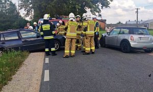 policjanci i strażacy zabezpieczają miejsce zdarzenia. widoczne rozbite auta