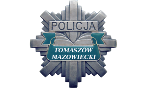 Policyjna odznaka z napisem Policja Tomaszów Mazowiecki.