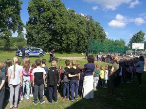 umundurowani policjanci uczestniczą w spotkaniu z dziećmi, pokaz psa służbowego