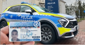 podrobione prawo jazdy na tle radiowozu.