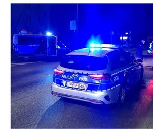 radiowozy z włączonymi światłami błyskowymi w porze nocnej,