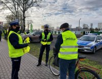 policjanci i przedstawiciele stowarzyszenia wręczają kamizelki odblaskowe.