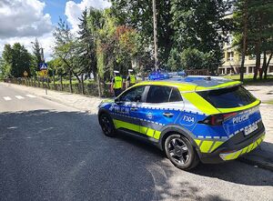 policjanci wokół szkoły dokonują lustracji oznakowania.