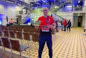 Policjant z Brzezin z medalem i statuetką.