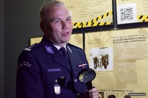 Inspektor Robert Krawczyk podczas udzielania wywiadu, w sali wystawowej.